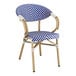 A blue and white Lancaster Table & Seating Teslin outdoor arm chair with wooden legs.