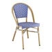 A blue and white striped Lancaster Table & Seating outdoor side chair with a wooden frame.