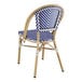 A blue and white Lancaster Table & Seating outdoor side chair with a wooden frame.