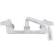 A chrome Equip by T&S wall mount faucet with 10 1/8" swing spout and lever handles.