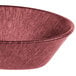 A raspberry polyethylene oval basket with a handle.