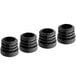 Four black plastic inserts with a hole in the middle.
