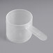 A clear plastic measuring scoop with a handle.