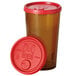 A close-up of a red plastic lid with a straw slot.