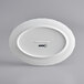 An Acopa Condesa white porcelain platter with a scalloped oval rim and black text.