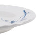 A white melamine plate with blue bamboo designs on the rim.