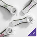 A set of gray and white customizable multi-purpose openers with various logos printed on them.