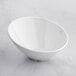 An Acopa white melamine bowl on a white surface.