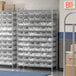 A Regency metal wire shelving unit with clear plastic bins on the shelves.