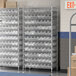 A Regency metal wire shelving unit with clear plastic bins on each shelf.