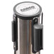 A chrome Aarco crowd control stanchion with dual red retractable belts.