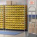A Regency wire shelving unit with yellow bins on the shelves.