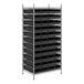 A metal wire shelving unit with black bins on the shelves.