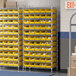 A Regency wire shelving unit with yellow bins on metal shelves.