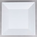 A white square plate with a white rim.