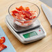 A stainless steel AvaWeigh portion control scale with a bowl of lobster meat on it.