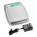 A stainless steel digital portion control scale with a display screen and an included power adapter.