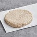A Rastelli's raw turkey burger on white paper.