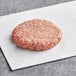 A raw Rastelli's American Wagyu burger on white paper.