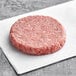 A raw Rastelli's American Wagyu burger on white paper.