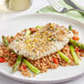 A plate of food with Rastelli's Wild Caught Icelandic Cod and asparagus with a fork and knife on a napkin.