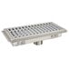A metal Advance Tabco floor trough with a fiberglass drain grate.
