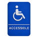 A white sign with a blue symbol of a person in a wheelchair and the word "accessible" in blue.