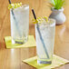 A glass of Tractor Beverage Co. organic lemonade with a straw and a lemon peel.