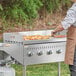 a person cooking food on a grill