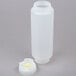 A white plastic bottle with a yellow lid.