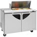 A Turbo Air stainless steel refrigerated sandwich prep table with glass doors on top.