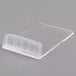 A clear plastic container with a clear lid holding white and black cards with chalk writing on them.