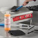 A griddle cleaning starter kit including a bottle of cleaner, scrubbing pads, and cleaning tools.