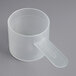 A close-up of a plastic measuring scoop with a short handle.