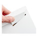 A white tab-locking rigid mailer being closed by hand.