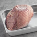 A Shaffer Venison Farms boneless venison shoulder roast wrapped in mesh.