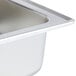 A Vollrath stainless steel water pan with a drain.