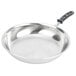 A close-up of a Vollrath stainless steel frying pan with a black silicone handle.