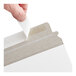 A white self-sealing rigid mailer with a peel-and-seal adhesive strip being opened.