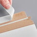 A person opening a white Lavex Stayflats mailer.