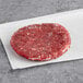 A raw Shaffer Venison Farms venison burger on white paper.