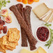 A plate of Shaffer Venison Farms venison jerky, cheese, and fruit.
