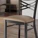 A taupe vinyl padded seat for a metal chair.