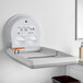 A Koala Kare white granite vertical surface-mounted baby changing table on a wall.