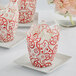 A close-up of a red and white tulip cupcake wrapper with a cupcake inside.