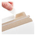 A white self-sealing rigid mailer with a peel-and-seal adhesive strip being opened.