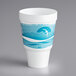 a white cup with blue and white design