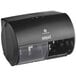 A black Compact by GP Pro double coreless roll toilet paper dispenser on a counter.