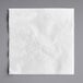 A white Dixie paper dinner napkin with a swirl design.