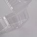 A Durable Packaging clear plastic container with a hinged lid.